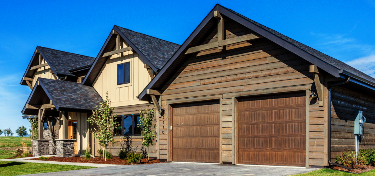 A beautiful stone and wood home that's primarily brown in color during the summertime.