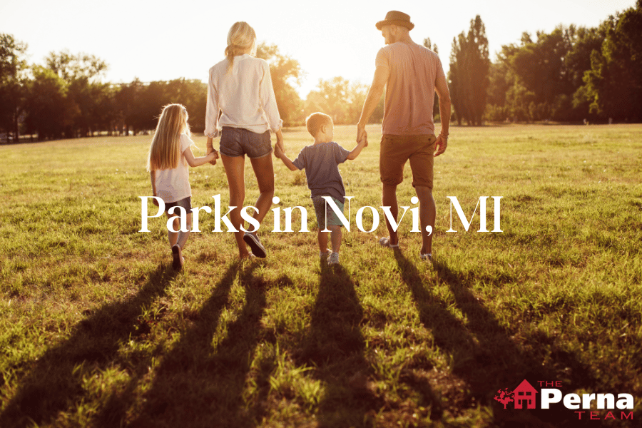 Family holding hands as they walk through a park in Novi, Michigan