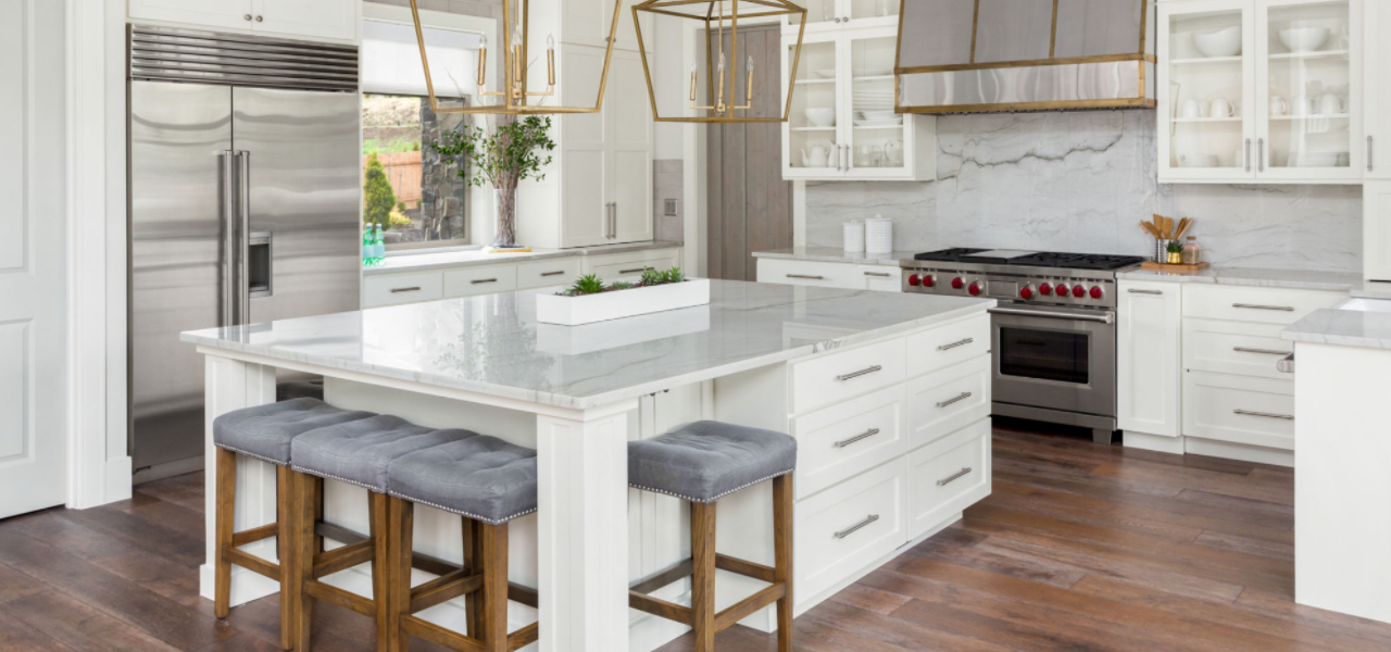 A stunning modern looking kitchen that's predominately white.
